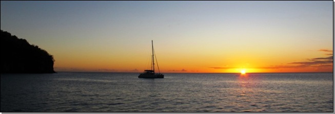 Sunset with a catamaran at the anchorage in Anse Chaudire, Martinique